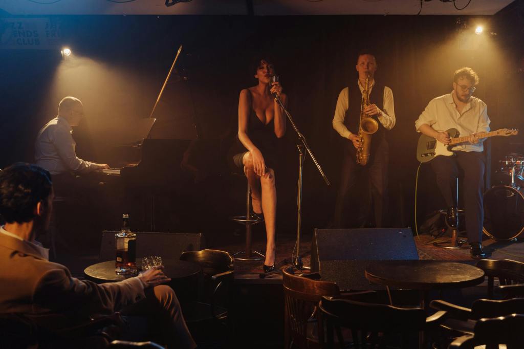 Jazz singer performing live with a band, highlighting the craft and dedication behind professional vocals.