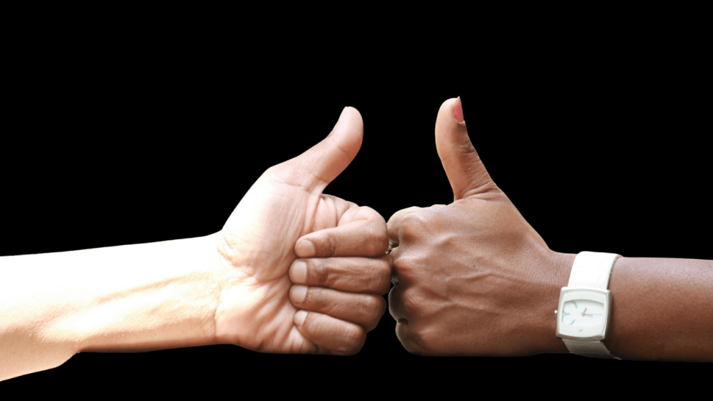 Two hands giving a thumbs up, symbolizing ethical collaboration and consent in AI projects.
